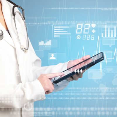 Female doctor holding tablet with blue background and heart related charts